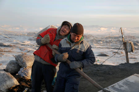 People work at a primitive coal mine outside Ulaanbaatar, Mongolia January 27, 2017. The miners at the Nalaikh coal deposit, outside the Mongolian capital, go as much as 60 meters underground to mine the coal. REUTERS/B. Rentsendorjj