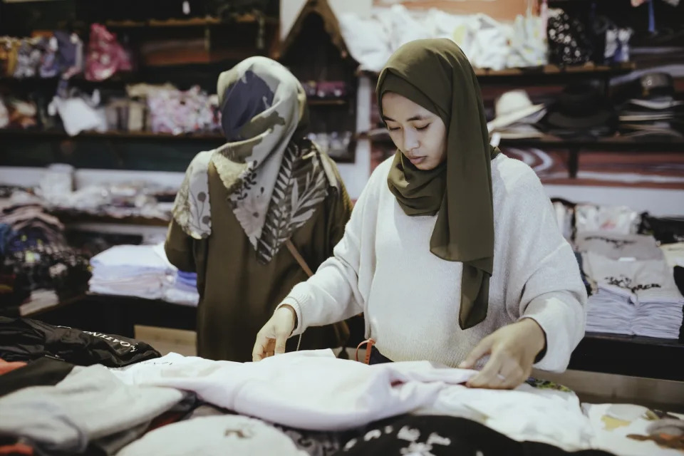 Two bumiputera women in a clothes store