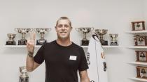<p>Fanning poses in front of an extensive set of career trophies.</p>