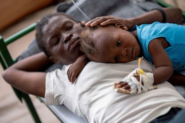 PHOTO: Karina Joseph, 19, comforts her 2-year-old child Holanda Sineus as she receives treatment for cholera in a tent at a Doctors Without Borders hospital in Cite Soleil, a densely populated commune of Port-au-Prince, Haiti, Octt. 15, 2022. (Ricardo Arduengo/Reuters)