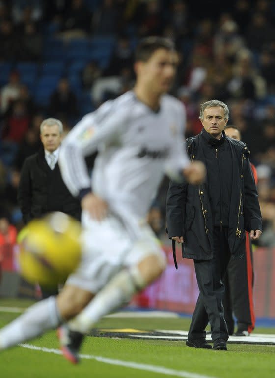 Real Madrid's coach Jose Mourinho (R), pictured during their Spanish La Liga match against Espanyol, at the Santiago Bernabeu stadium in Madrid, on December 16, 2012. After defeats at Getafe, Sevilla and Betis, followed by the draw with Espanyol, Mourinho admitted the title was "almost impossible now."