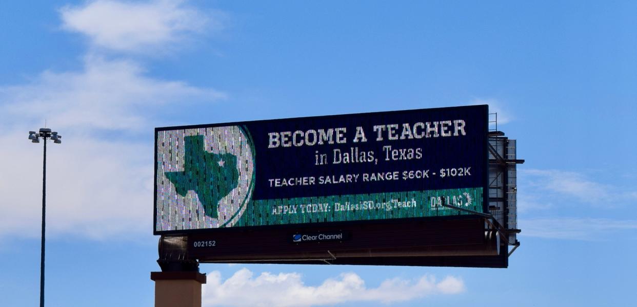 Along Interstate 17 near Glendale Avenue, a billboard reads: "Become a Teacher in Dallas, Texas. Teacher Salary Range $60K-$102K. Apply Today: DallasISD.org/Teach."