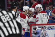 Montreal Canadiens right wing Denis Gurianov (25), left wing Jonathan Drouin (27) and center Kirby Dach (77) celebrate after defenseman Jordan Harris, behind right, scored against the Buffalo Sabres during the first period of an NHL hockey game in Buffalo, N.Y., Monday, March 27, 2023. (AP Photo/Adrian Kraus)