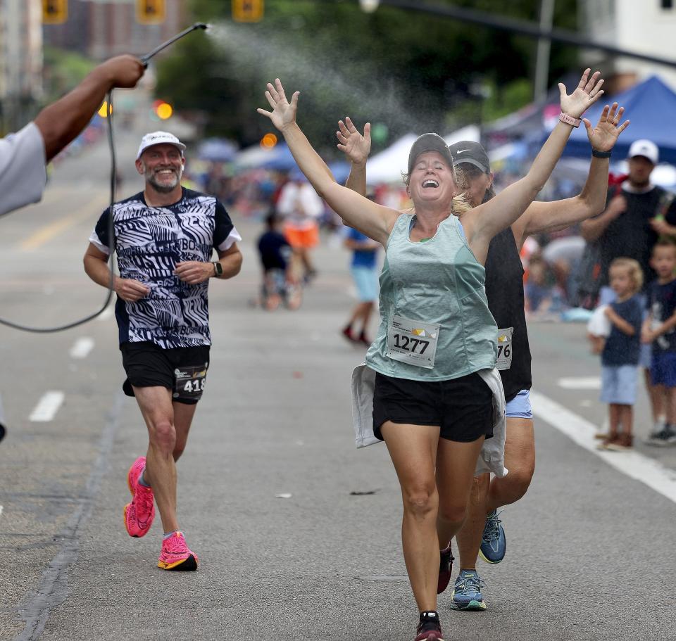 Runners enjoy getting watered down while competing in the Deseret News Marathon races in Salt Lake City on Monday, July 24, 2023. | Laura Seitz, Deseret News