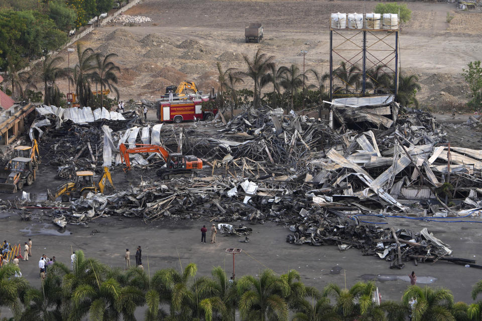 Earthmovers remove burnt debris the day after a fire broke out in an amusement park in Rajkot, India, Sunday, May 26, 2024. A massive fire damaged a large part of the park on Saturday, killing more than twenty people and injuring some others, news reports said. (AP Photo/Ajit Solanki)