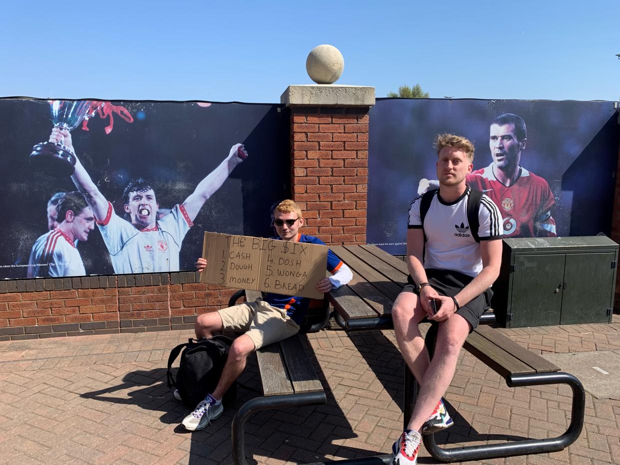 (Left) Jacob Ward, 21 and (Right) Dean Heslin, 30, football fans protesting outside Old Trafford against the European Super League (Gemma Bradley/PA)