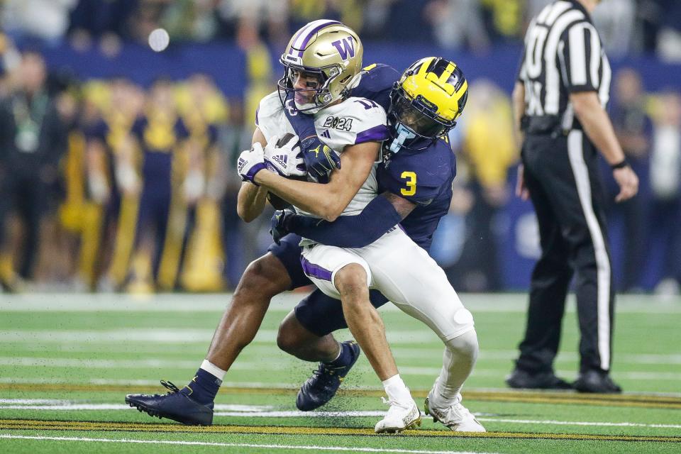 Michigan defensive back Keon Sabb tackles Washington wide receiver Jalen McMillan during the first half of the national championship game at NRG Stadium in Houston, Texas on Monday, Jan. 8, 2024.