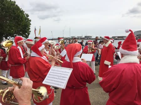 Musicians dressed as Santa Claus perform during the World Santa Claus Congress in Copenhagen