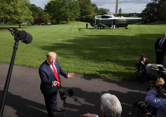 President Donald Trump talks to journalists on the South Lawn while departing the White House for Camp David on 1 May, 2020 (Chip Somodevilla/Getty Images)