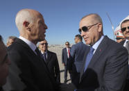 Turkey's President Recep Tayyip Erdogan, right, and Tunisian President Kais Saied, speak as they meet at the airport, in Tunis, Tunisia, Wednesday, Dec. 25, 2019. Erdogan with top Turkish officials is on an unannounced visit to Tunisia to meet Saied. (Turkish Presidency via AP, Pool)