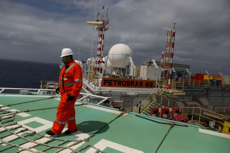 FILE PHOTO: A worker walks on the heliport at the Brazil's Petrobras P-66 oil rig in the offshore Santos basin in Rio de Janeiro