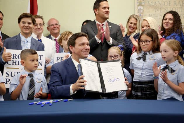 Florida Gov. Ron DeSantis displays the signed 