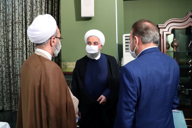 Iranian President Hassan Rouhani is seen wearing a face mask during a meeting, in Tehran