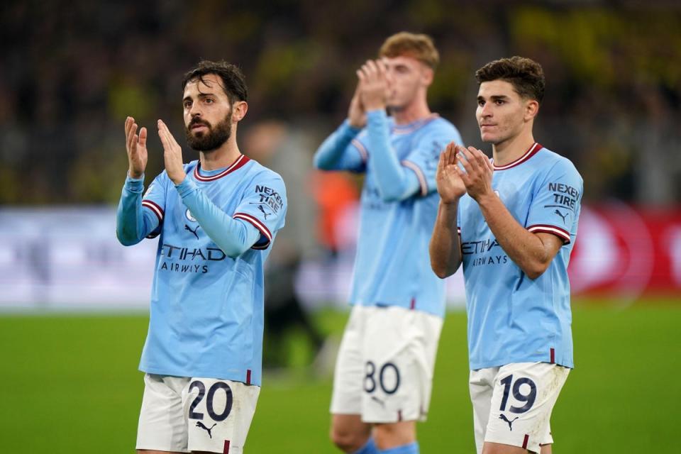 Manchester City’s Bernardo Silva and Julian Alvarez applaud their fans after their goalless draw in Dortmund (Tim Goode/PA) (PA Wire)