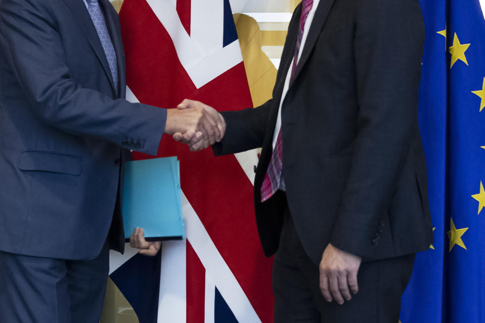 UK Brexit secretary Stephen Barclay, right, shakes hands with European Union chief Brexit negotiator Michel Barnier before their meeting at the European Commission headquarters in Brussels, Friday, Oct. 11, 2019. (AP Photo/Francisco Seco, Pool)