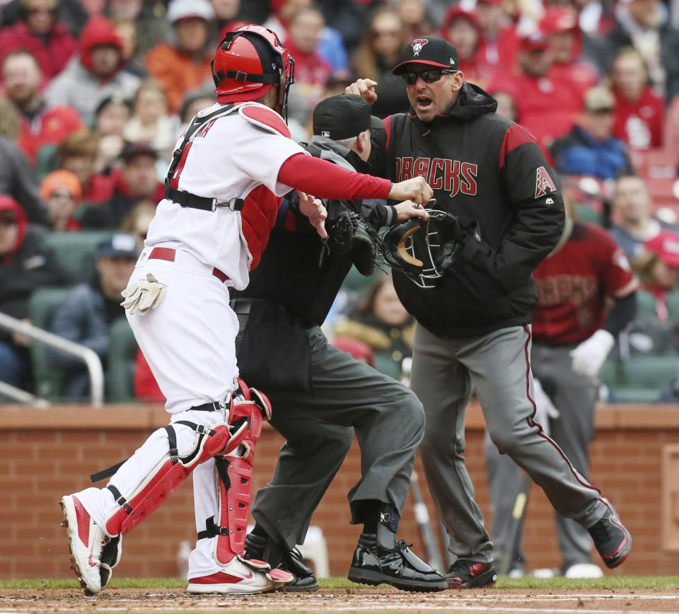 Diamondbacks manager Torey Lovullo gestures at Cardinals catcher Yadier Molina as he argues balls and strikes with home plate umpire Tim Timmons on Sunday. Molina took offense to Lovullo’s comments, which led to a bench-clearing scuffle. (AP)