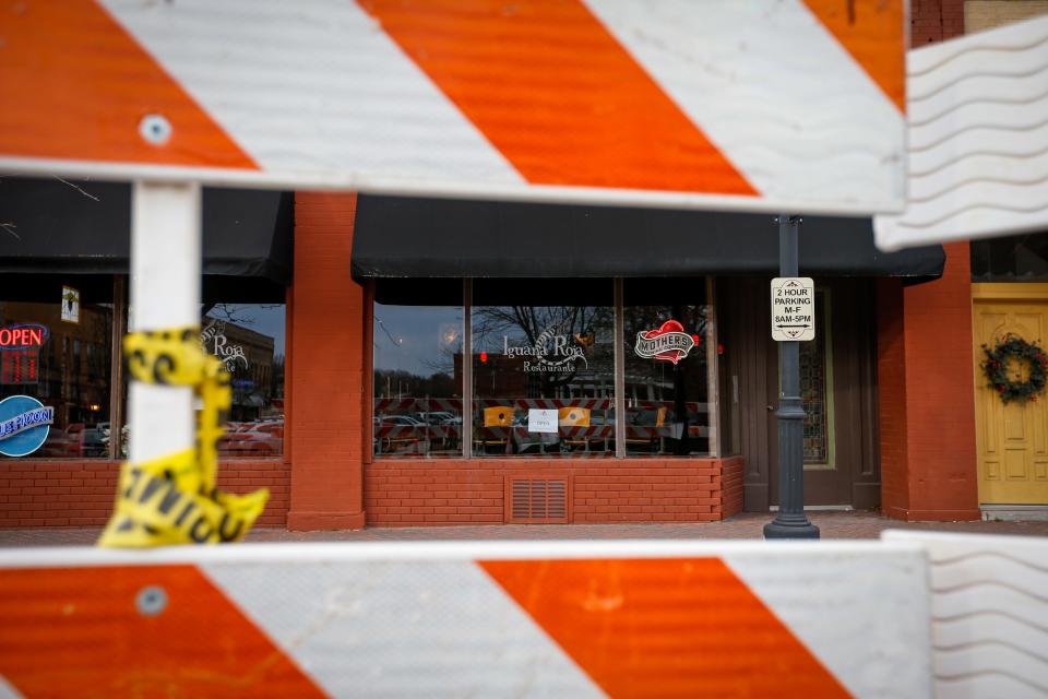 Barricades block off parking spaces in front of Iguana Roja Restaurante along Church Street in downtown Ozark on Wednesday, Jan. 11, 2023. Demolition on a former building at 101 W. Church St. was completed on Wednesday. The building collapsed, without warning, on Thursday, Dec. 29, 2022.