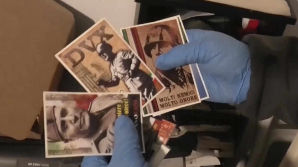 This picture taken from a publicly distributed police video shows some of the items recovered in the homes of 24 people investigated for apology of Fascism in Ferrara, northern Italy, Wednesday, Feb. 14, 2024. Italian police on Wednesday raided the homes of 24 people under investigation for apology of fascism inciting racial hatred during a gathering at a restaurant in the Jewish quarter of Ferrara during which they lauded dictators Benito Mussolini and Adolf Hitler. (Italian Police via AP)