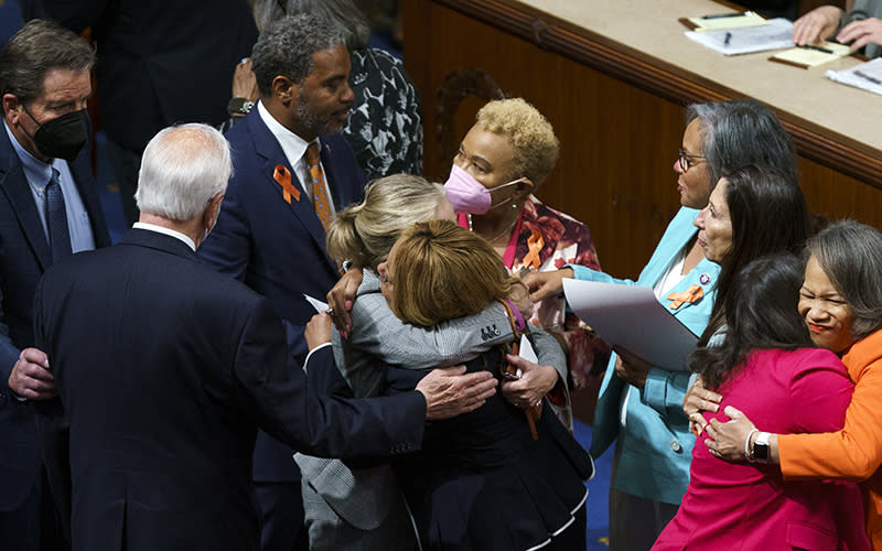 House Democrats hug and celebrate after the passage of the Bipartisan Safer Communities Act