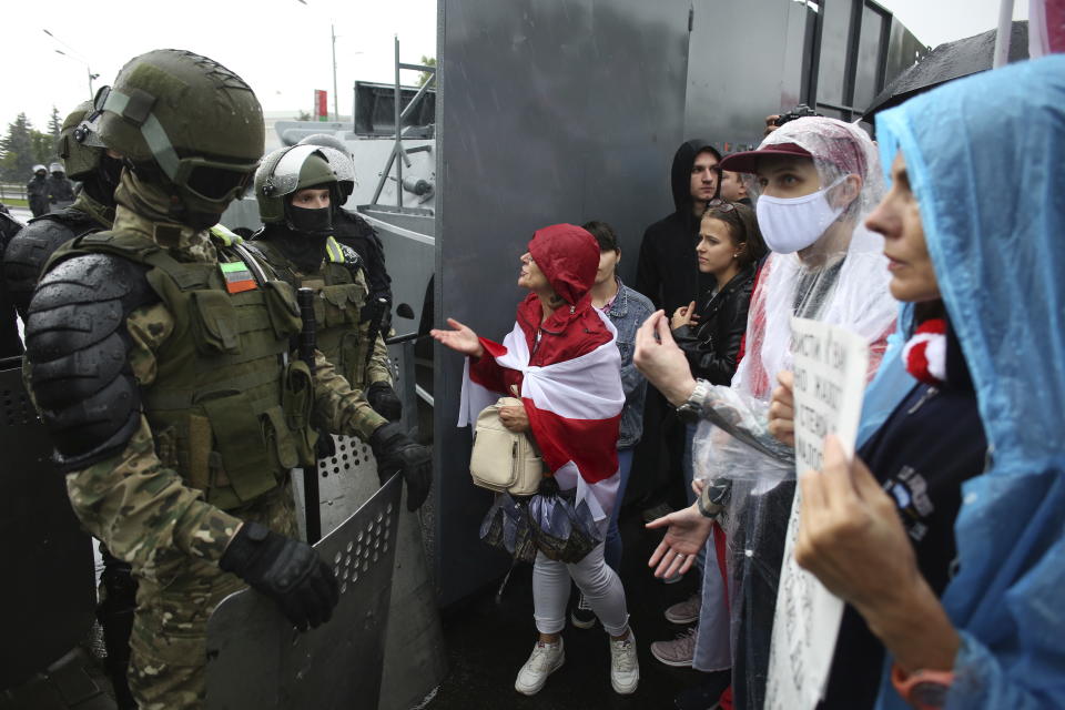 Belarusian opposition supporters try to speak to riot policemen as they gather in front of a police line toward the Independence Palace, residence of the President Alexander Lukashenko, in Minsk, Belarus, Sunday, Sept. 6, 2020. Sunday's demonstration marked the beginning of the fifth week of daily protests calling for Belarusian President Alexander Lukashenko's resignation in the wake of allegedly manipulated elections. (AP Photo/TUT.by)