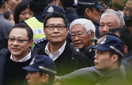 (L-R) Professor at the University of Hong Kong Benny Tai, professor of sociology at Chinese University Chan Kin-man, Former head of the Catholic Church in Hong Kong Cardinal Joseph Zen and Reverend Chu Yiu-ming walk to the Central Police Station before voluntarily surrendering themselves to the police in Hong Kong December 3, 2014. REUTERS/Bobby Yip