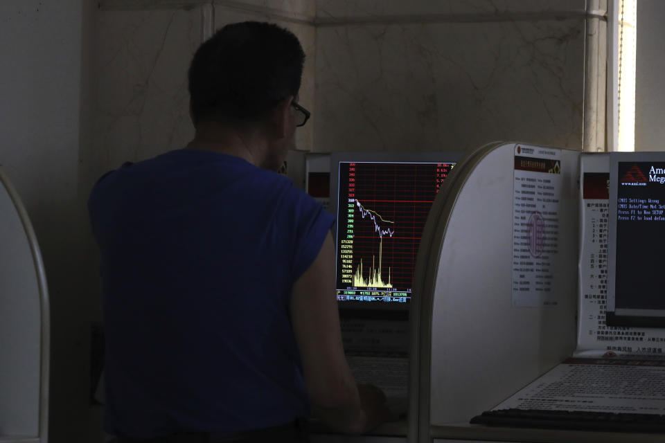 An investor monitors prices at a stock brokerage in Beijing on Tuesday, April 23, 2019. Asian stocks were mixed on Tuesday while oil prices soared to their highest level since October after the U.S. said it would soon impose sanctions on all buyers of Iranian oil. (AP Photo/Ng Han Guan)