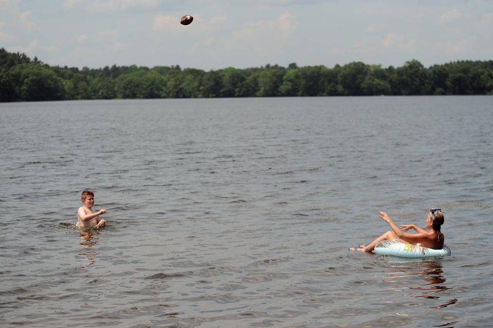 Rachel Gingras, and Aiden Gingras, 10, of Westborough, enjoyed a football catch at the Lake Chauncy Beach, June 28, 2021.