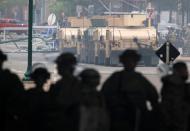 Armoured vehicles are pictured as National Guard members guard the area in the aftermath of a protest, in Minneapolis