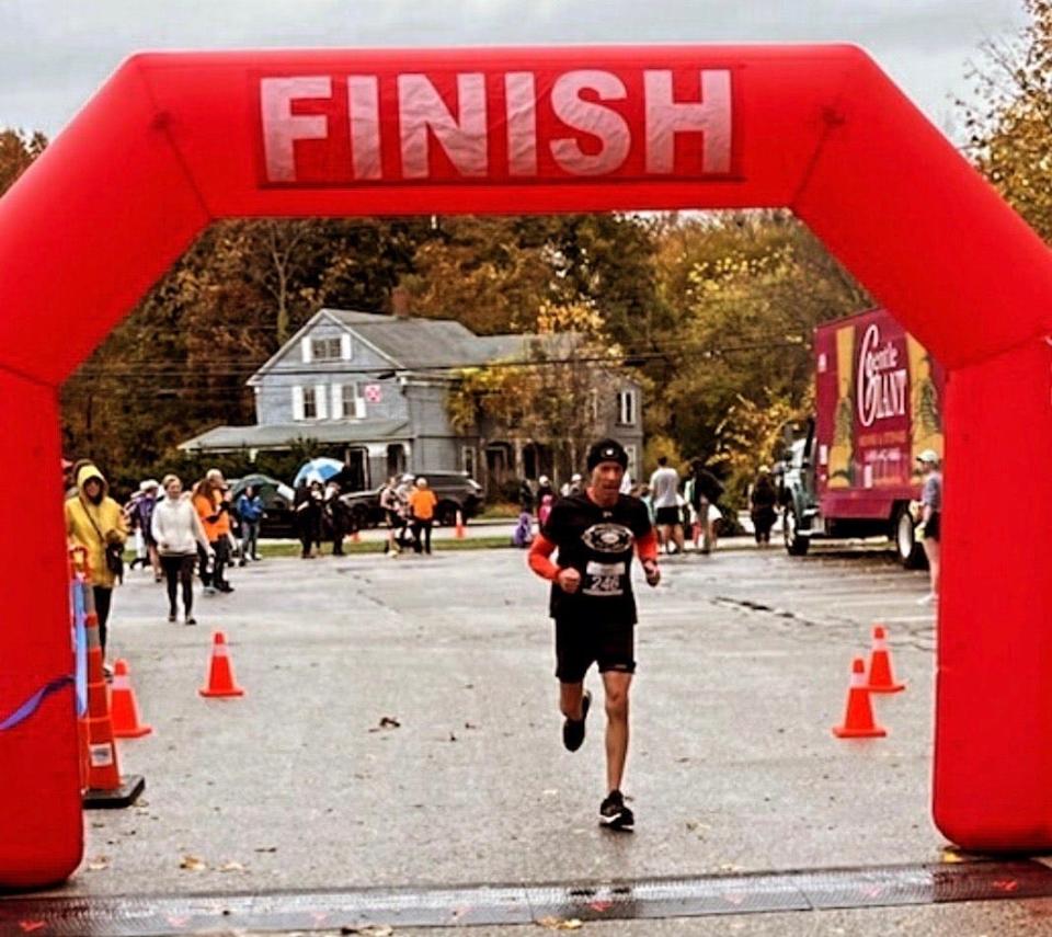 Neil Levine, of Mansfield, a co-owner of Maguire's Bar and Grill in Easton, completes a road race in the fall of 2023.