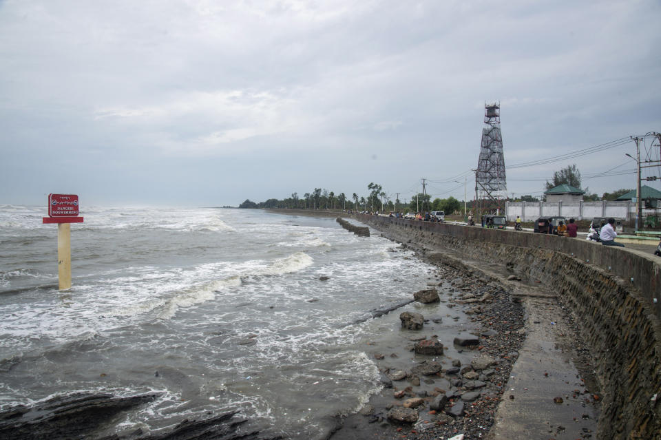 Locals stand the bank of sea before Cyclone Mocha hits, in Sittwe, Rakhine State, Saturday, May 13, 2023. Authorities in Bangladesh and Myanmar are preparing to evacuate hundreds of thousands of people as they brace for a severe cyclone churning in the Bay of Bengal. (AP Photo)