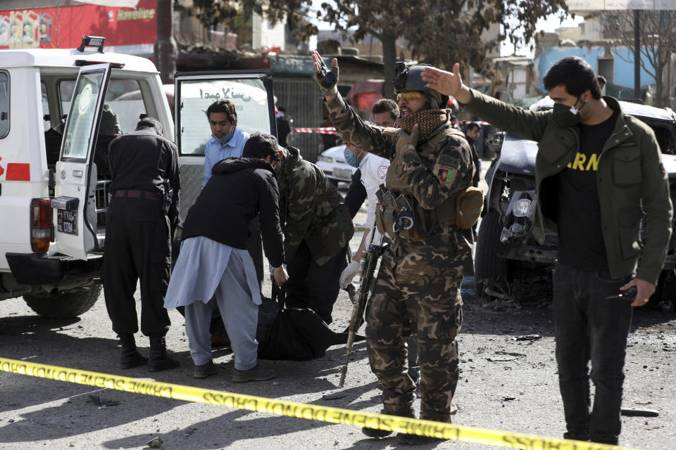 Security personnel inspect the site of a deadly bomb attack in Kabul, Afghanistan, Wednesday, Feb. 10, 2021. (AP Photo/Rahmat Gul)