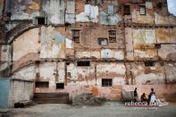 People wait to make a sale in the market where lumber, sand and other building products are stored in this neighborhood of Havana called Vieja.