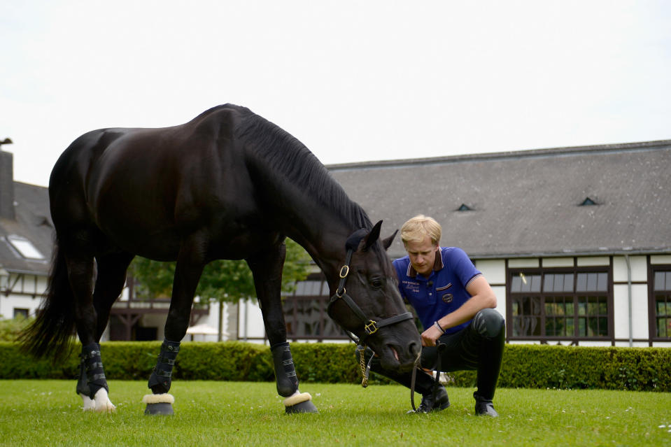 German dressage rider Matthias Alexander Rath poses with his horse Totilas during a portrait session on June 19, 2012. (Photo by Dennis Grombkowski/Bongarts/Getty Images)