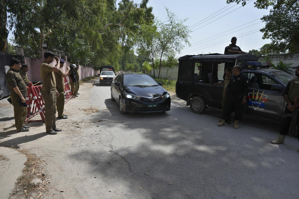 Police officers salute to a car carrying a judge of special court leaving after a case hearing of Pakistan's former Prime Minister Imran Khan at the District Jail, in Attock, Pakistan, Wednesday, Aug. 30, 2023. A court asked the official in charge of the Attock prison to keep former Prime Minister Khan there until at least Wednesday, when Khan is expected to face a hearing on charges of "exposing an official secret document" in an incident last year when he waved a confidential diplomatic letter at a rally. The Islamabad High Court on Tuesday suspended the corruption conviction and three-year prison term of him, his lawyers and court officials said. (AP Photo/Anjum Naveed)