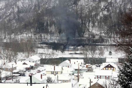 A CSX Corp train continues to smolder a day after derailing in Mount Carbon, West Virginia, Tuesday, February 17, 2015. REUTERS/Marcus Constantino