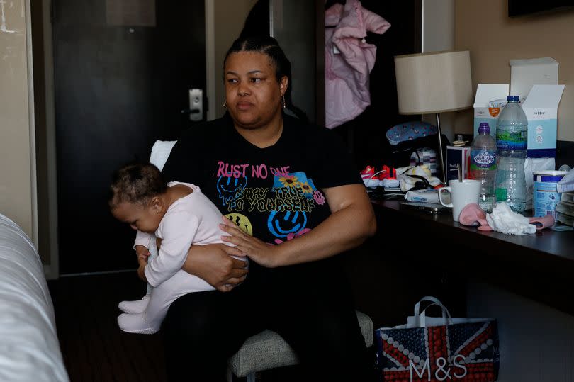 Decoda Smith poses in her hotel with her baby