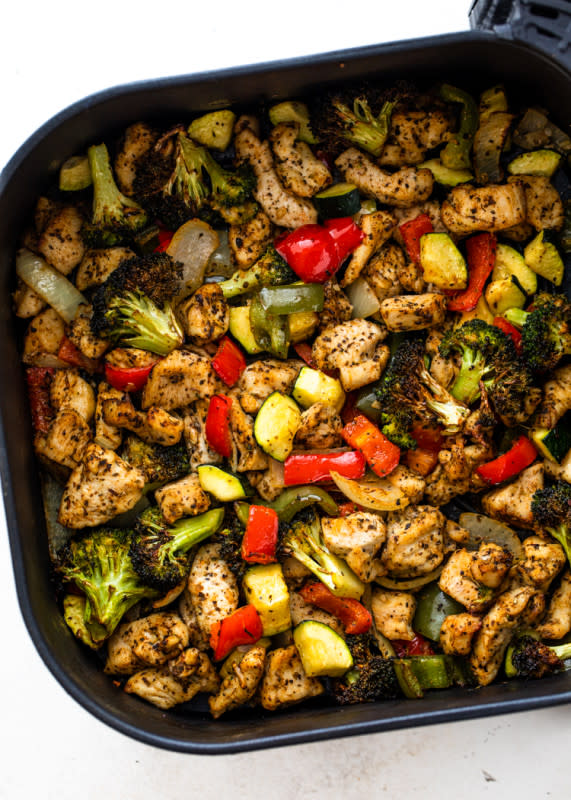 <p>This nutritious air fryer chicken and veggies recipe is so easy to make and full of flavor. It makes a complete and healthy low-carb or keto meal in under 20 minutes!</p><p><strong>Get the recipe: <a href="https://gimmedelicious.com/air-fryer-chicken-and-veggies/" rel="nofollow noopener" target="_blank" data-ylk="slk:Air Fryer Chicken and Veggies;elm:context_link;itc:0;sec:content-canvas" class="link rapid-noclick-resp">Air Fryer Chicken and Veggies</a></strong></p>