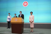 Hong Kong Chief Executive Carrie Lam, right, attends a news conference where she announces appointment of John Lee, second left, as the Chief Secretary, Chris Tang, second right, as the Secretary for Security and Raymond Siu as the Commissioner of Police in Hong Kong, Friday, June 25, 2021. China on Friday promoted Hong Kong’s top security official to the territory’s No. 2 spot as Beijing continues to clamp down on free speech and political opposition. (AP Photo/Kin Cheung)