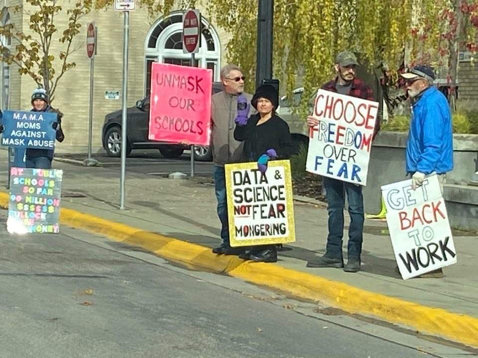 Dr. Annie Bukacek, center, in black, joins demonstrators in Kalispell protesting mask requirements in schools.