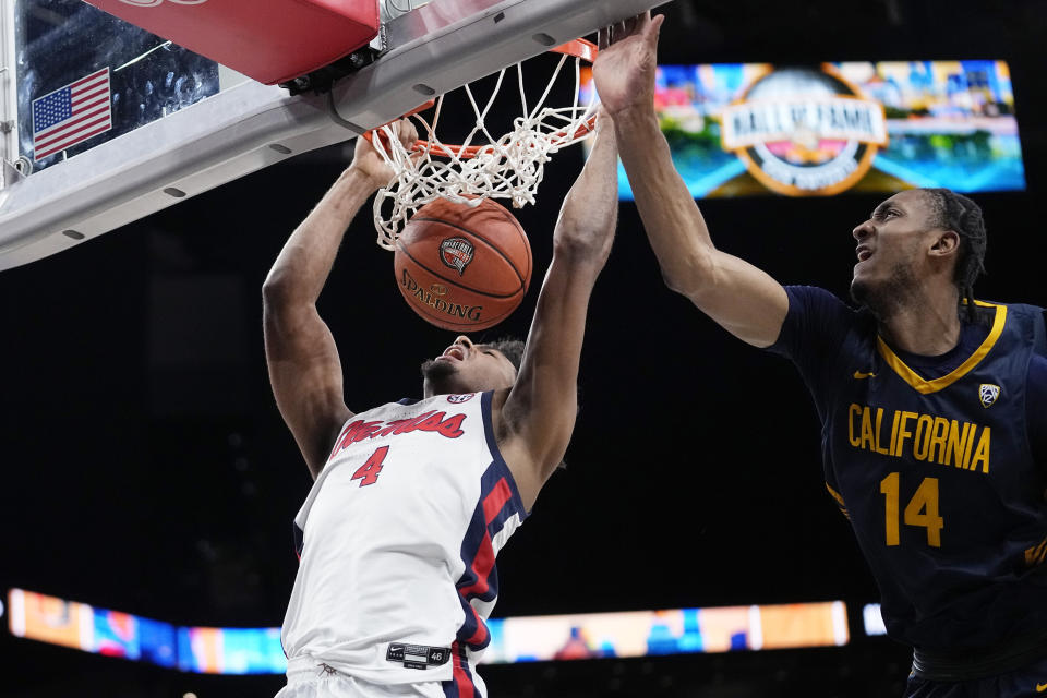 Mississippi forward Jaemyn Brakefield (4) scores past California forward Grant Newell (14) during the second half of an NCAA college basketball game in San Antonio, Saturday, Dec. 16, 2023. (AP Photo/Eric Gay)