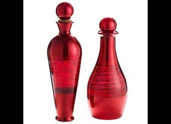 <a href="http://www.pier1.com/Catalog/HomeAccentsD%C3%A9cor/tabid/979/List/0/CategoryID/135/level/a/ProductID/34006/ProductName/Red-Foil-Glass-Bottles/Default.aspx" target="_hplink">Decanter-style bottles like these ones</a> bring an elevated look to a table. We like how the gleaming exterior of these bottles are reminiscent of ruby stones. 