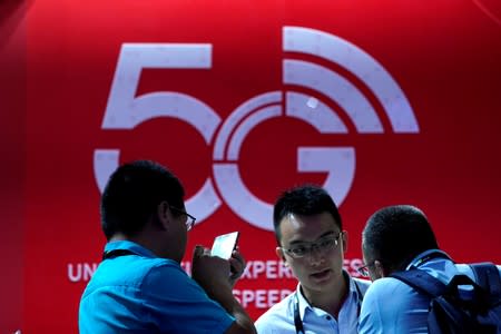 FILE PHOTO: A sign advertising 5G is seen at CES (Consumer Electronics Show) Asia 2019 in Shanghai