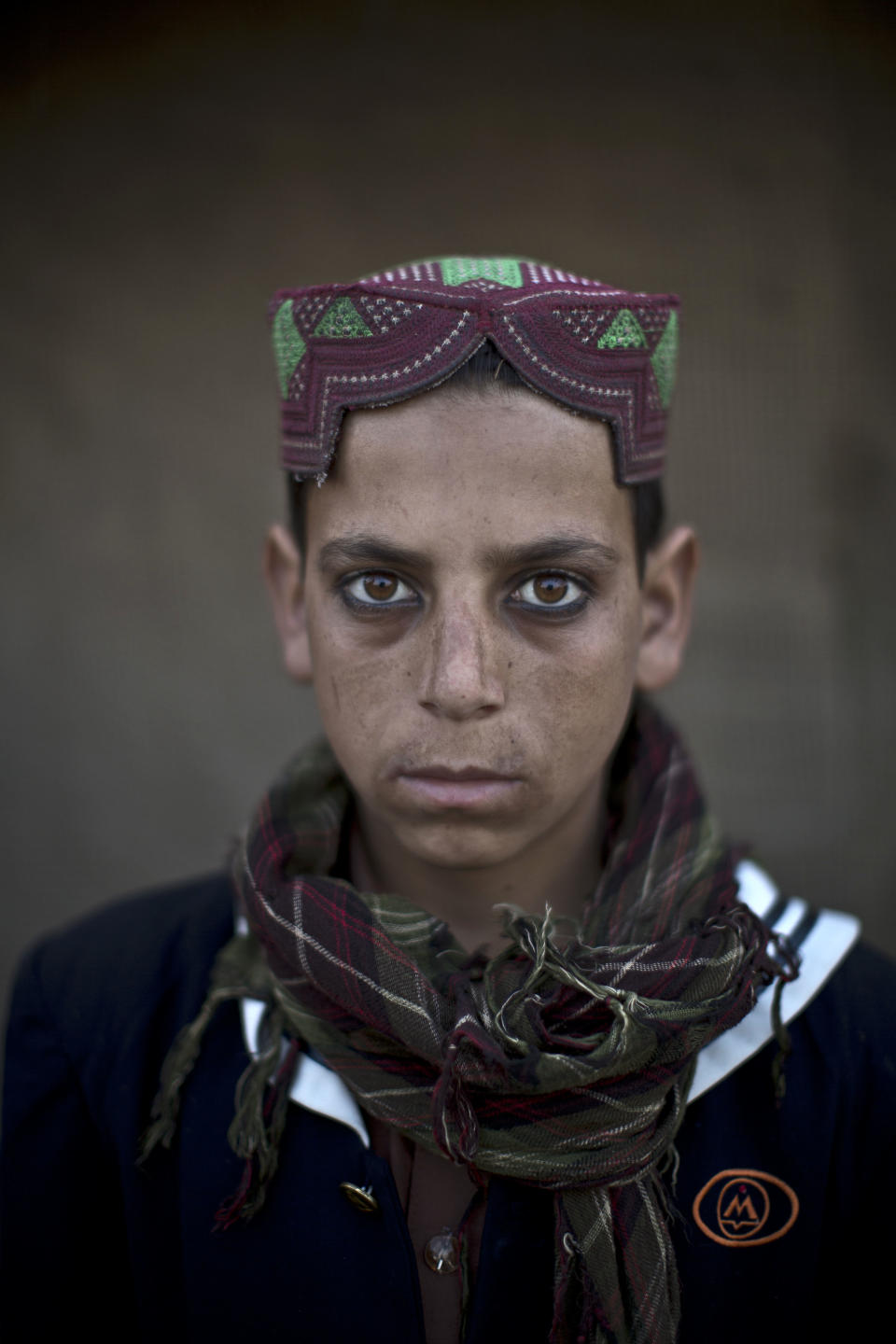 In this Friday, Jan. 24, 2014 photo, Afghan refugee boy, Akhtar Babrek, 13, poses for a picture, in a slum on the outskirts of Islamabad, Pakistan. For more than three decades, Pakistan has been home to one of the world’s largest refugee communities: hundreds of thousands of Afghans who have fled the repeated wars and fighting their country has undergone. Since the 2002 U.S.-led invasion of Afghanistan, some 3.8 million Afghans have returned to their home country, according to the U.N.’s refugee agency. (AP Photo/Muhammed Muheisen)