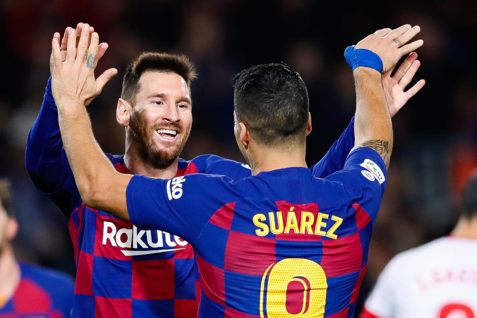 Lionel Messi celebrates with Luis Suarez during a 2019 match.