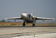 FILE - In this Oct. 22, 2015 file photo, a Russian Su-24 takes off on a combat mission at Hemeimeem airbase in Syria. The Russian military says its warship has fired warning shots and a warplane dropped bombs to force a British destroyer from Russia's waters near Crimea in the Black Sea. The incident on Wednesday June 23, 2021, marks the first time since the Cold War era when Moscow used live ammunition to deter a NATO warship, reflecting soaring Russia-West tensions. (AP Photo/Vladimir Isachenkov, File)