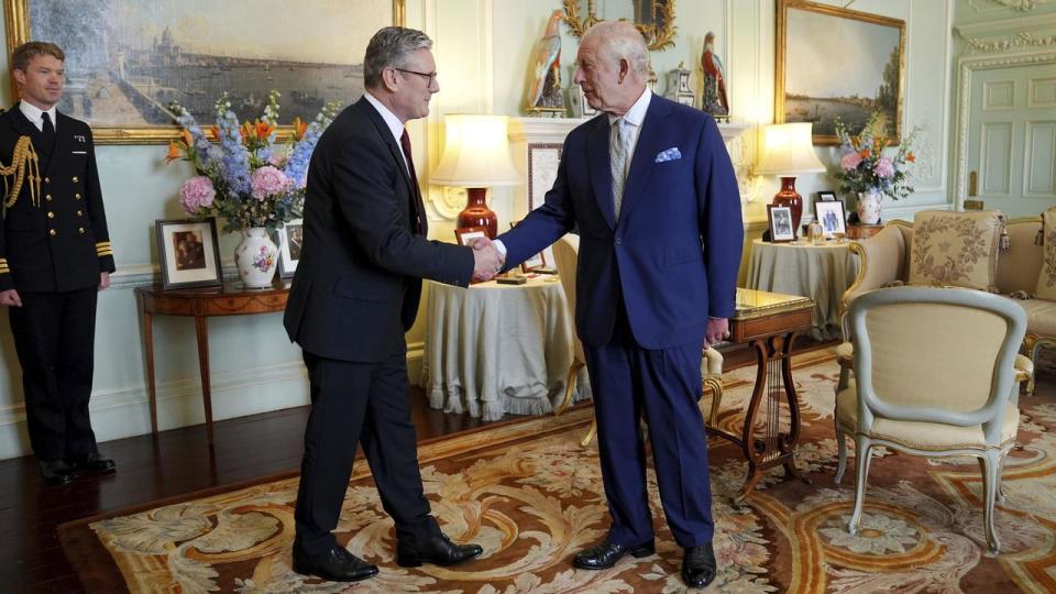 New Prime Minister Keir Starmer shakes hands with King Charles III