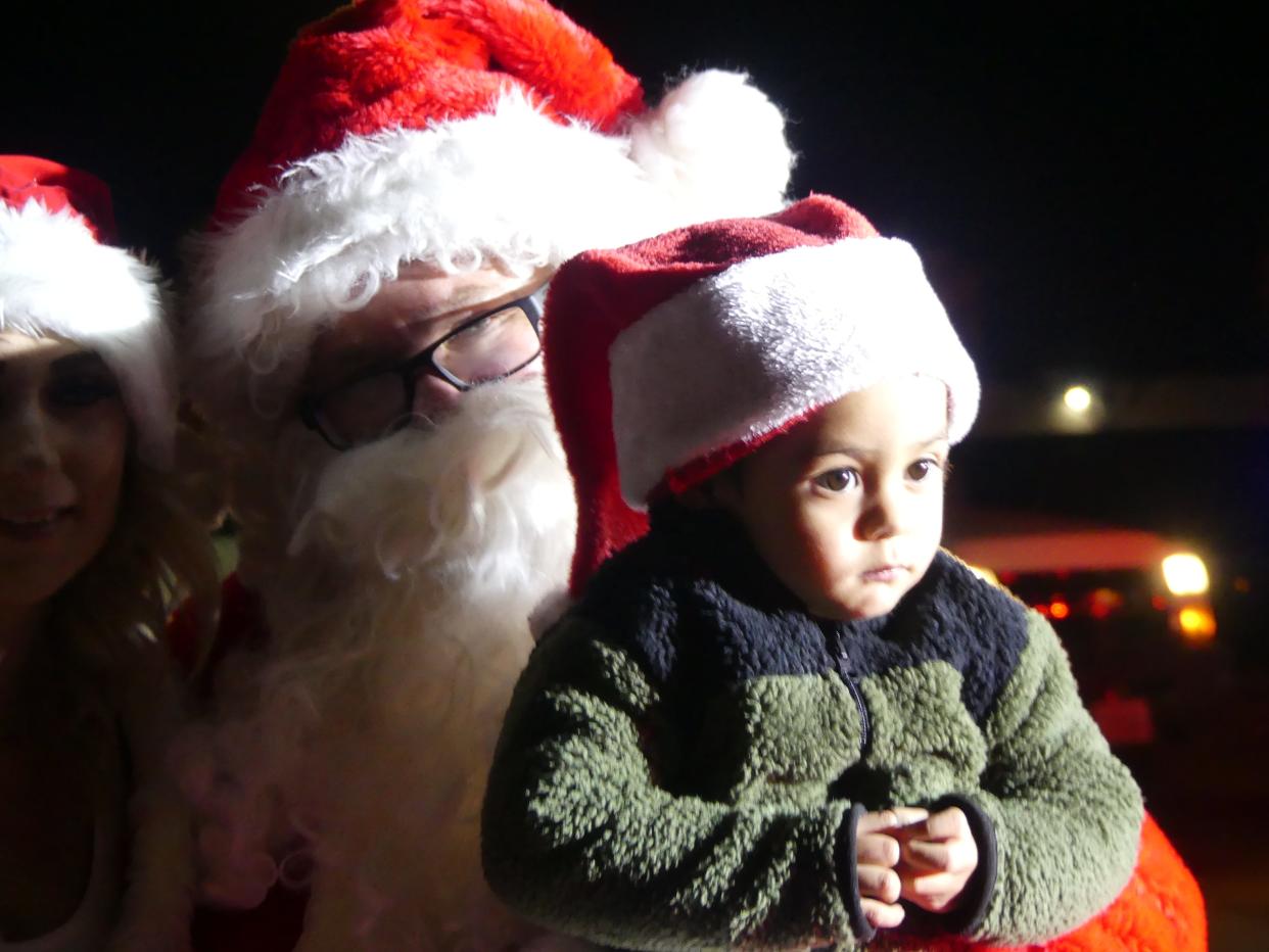 A young boy meets Santa Claus on Friday night at Civic Plaza Park next to Hesperia City Hall. The event was the end of the first responder Jolly Parade, which escorted Santa to several schools.
