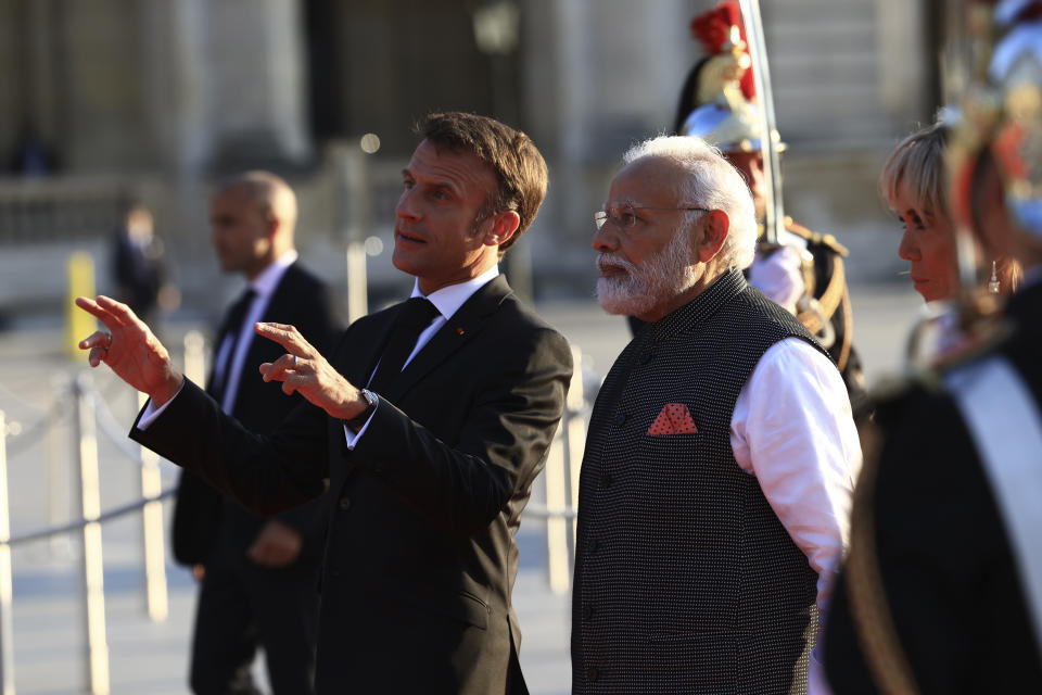 French President Emmanuel Macron welcomes Indian Prime Minister Narendra Modi at the Louvre museum before a dinner in Paris, Friday, July 14, 2023. France is looking to further strengthen cooperation on an array of topics ranging from climate to military sales and the strategic Indo-Pacific region. (AP Photo/Aurelien Morissard)