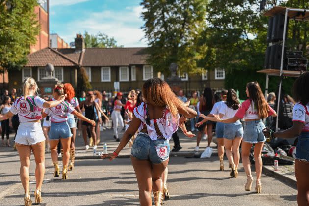 Students from the Paraiso School of Samba rehearse the day before the Notting Hill Carnival parade, as onlookers watch. (Photo: Clara Watt for HuffPost)