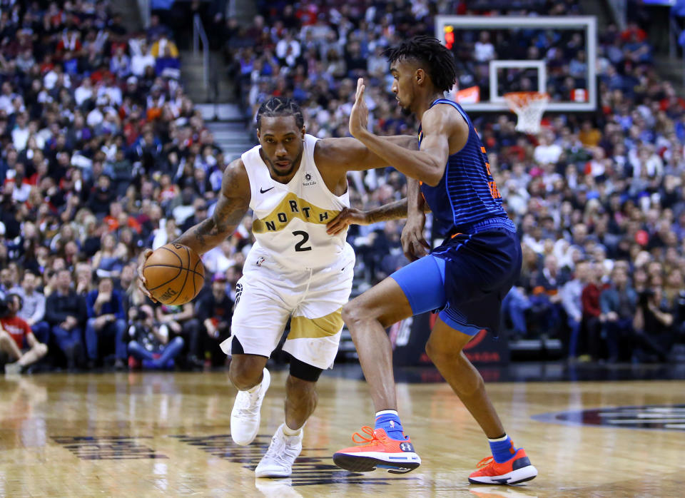 TORONTO, ON - MARCH 22:  Kawhi Leonard #2 of the Toronto Raptors dribbles the ball as Terrance Ferguson #23 of the Oklahoma City Thunder defends during the second half of an NBA game at Scotiabank Arena on March 22, 2019 in Toronto, Canada.  NOTE TO USER: User expressly acknowledges and agrees that, by downloading and or using this photograph, User is consenting to the terms and conditions of the Getty Images License Agreement.  (Photo by Vaughn Ridley/Getty Images)